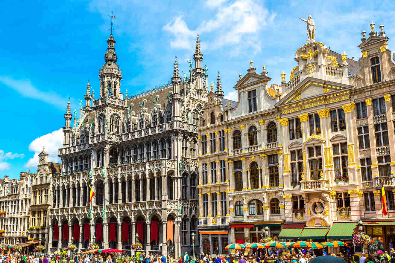 Grand Place in Brussels, with ornate guildhalls and bustling with tourists under a clear blue sky